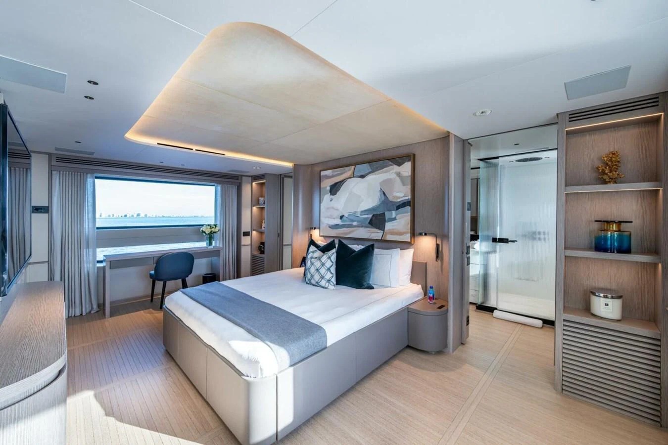 The master stateroom features a luxurious bed, modern decor, and ample natural light. aboard KING'S LAIR Yacht for Sale