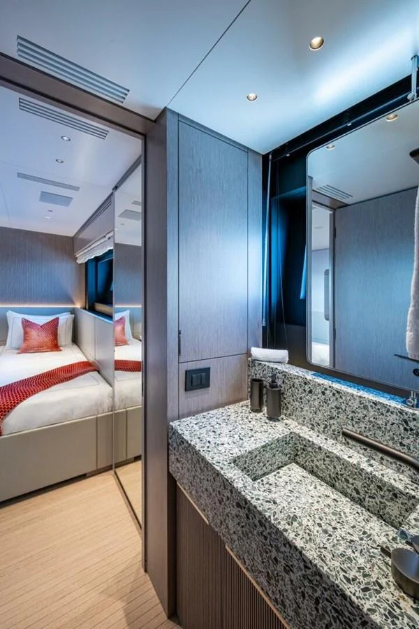 A luxurious stateroom featuring a stylish en-suite bathroom with modern fixtures. aboard KING'S LAIR Yacht for Sale