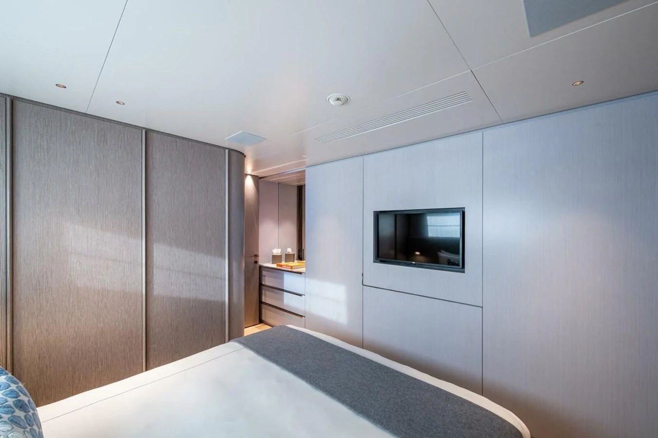The stateroom features a modern design with sleek finishes and a built-in entertainment system. aboard KING'S LAIR Yacht for Sale