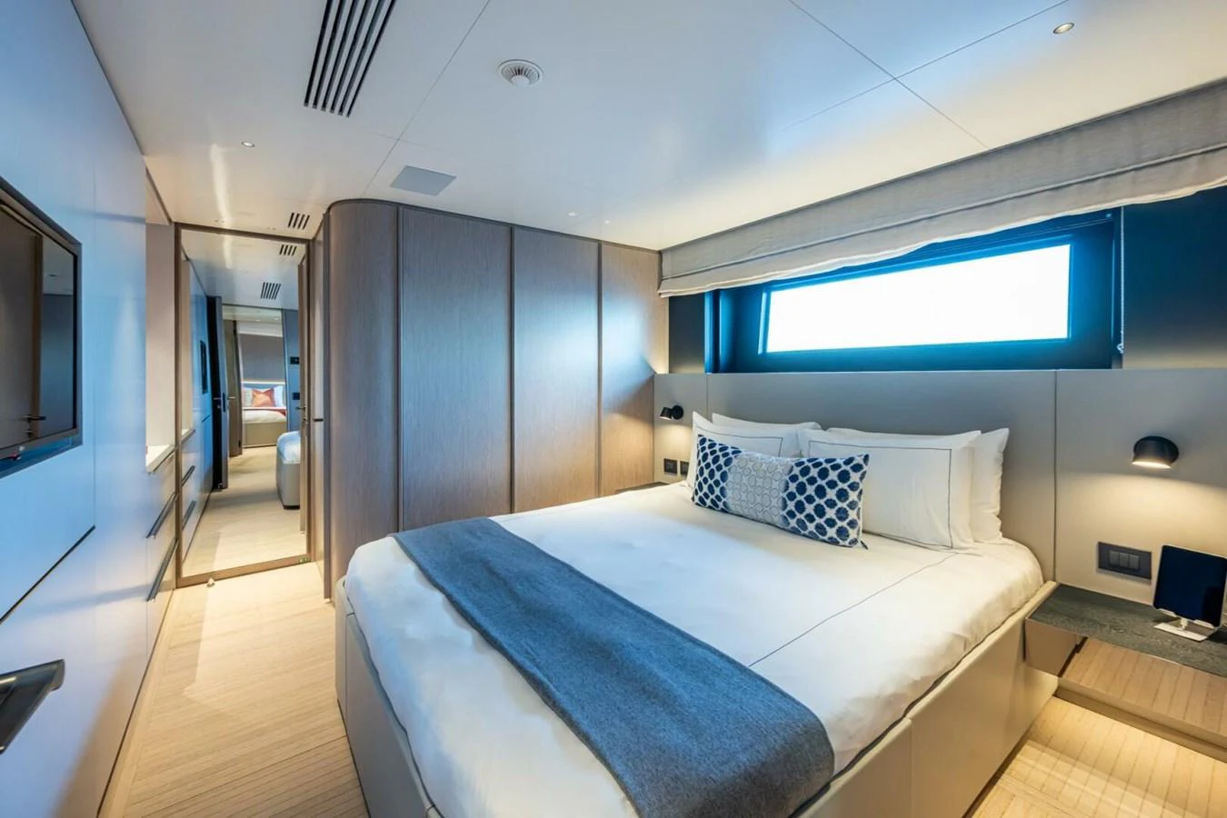 A luxurious stateroom featuring a large bed with plush bedding and modern decor. aboard KING'S LAIR Yacht for Sale