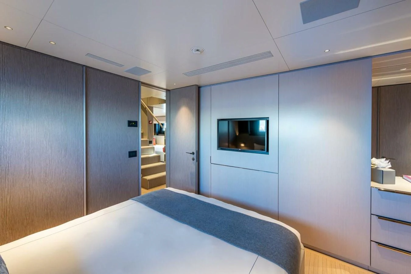 A luxurious stateroom featuring a comfortable bed and modern amenities. aboard KING'S LAIR Yacht for Sale
