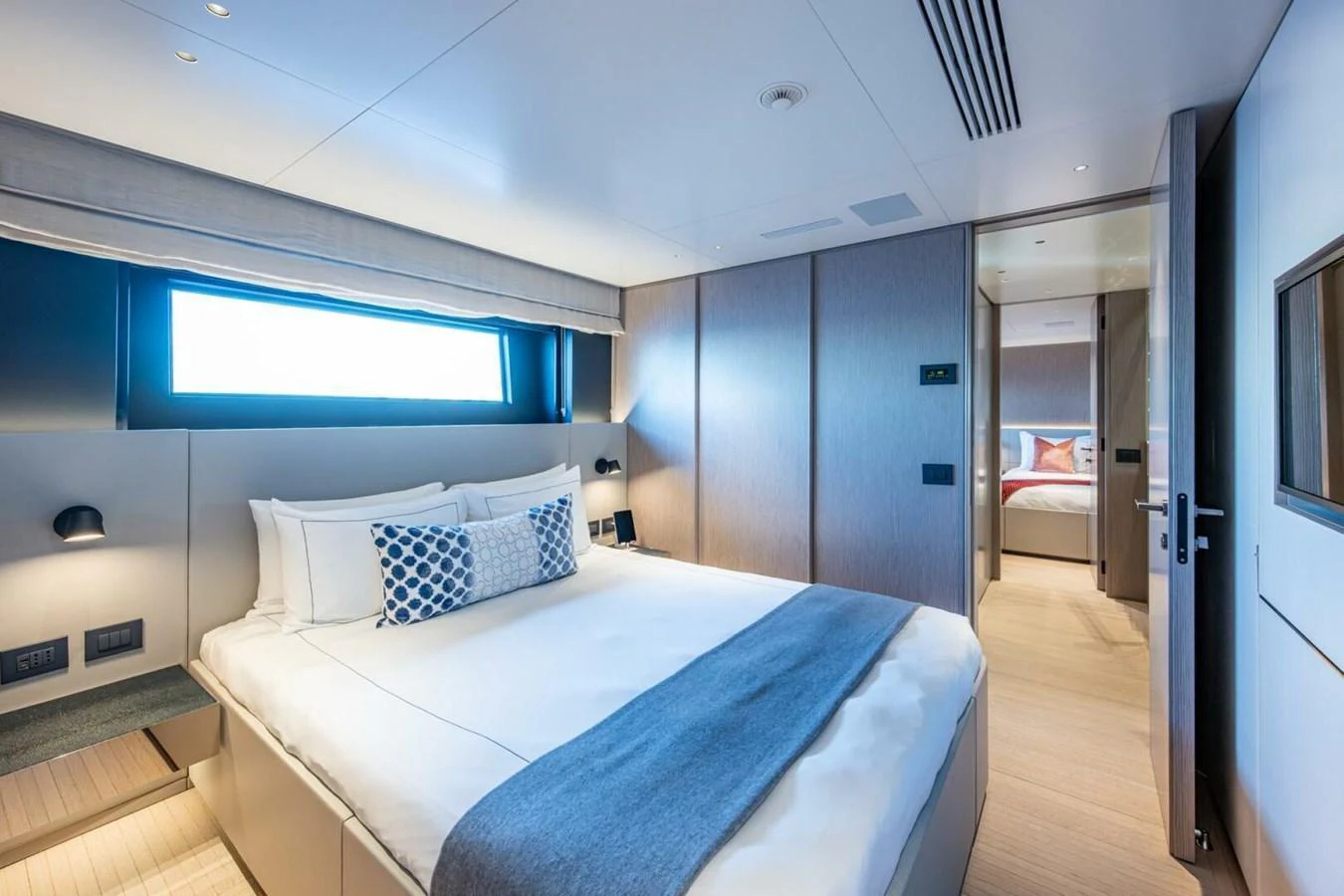 The stateroom features a luxurious bed with elegant bedding and modern decor. aboard KING'S LAIR Yacht for Sale