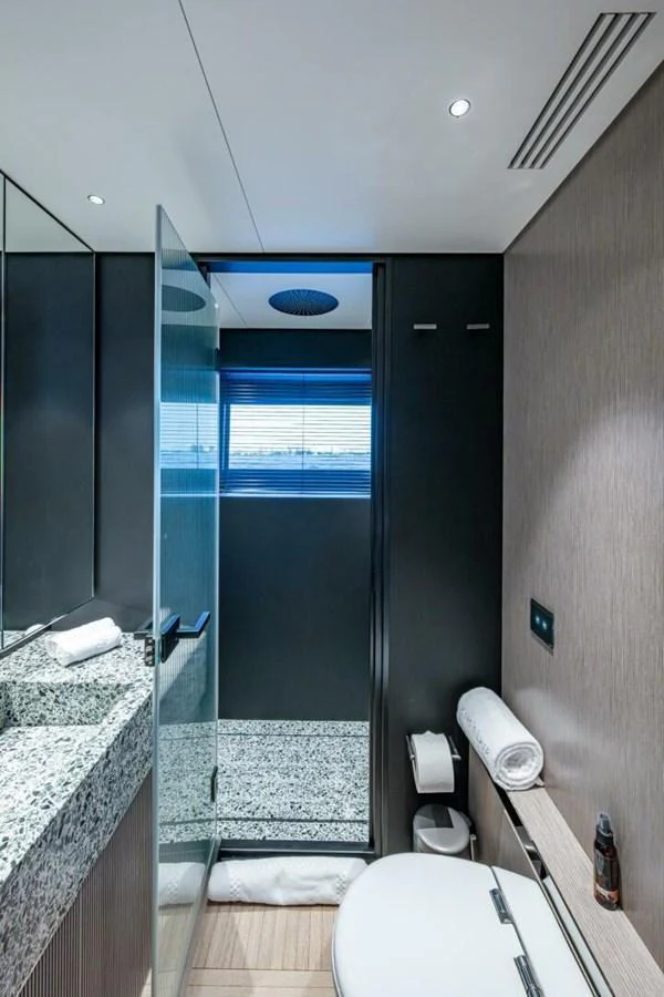 This modern yacht bathroom features sleek fixtures and a spacious shower area. aboard KING'S LAIR Yacht for Sale