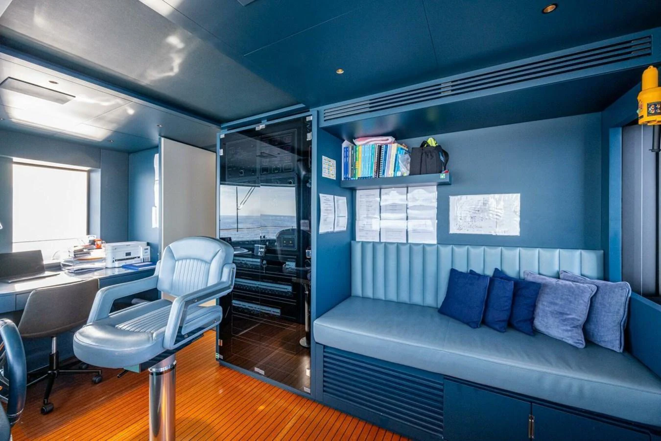 The yacht's office features a comfortable seating area and a well-equipped workspace with ocean views. aboard KING'S LAIR Yacht for Sale