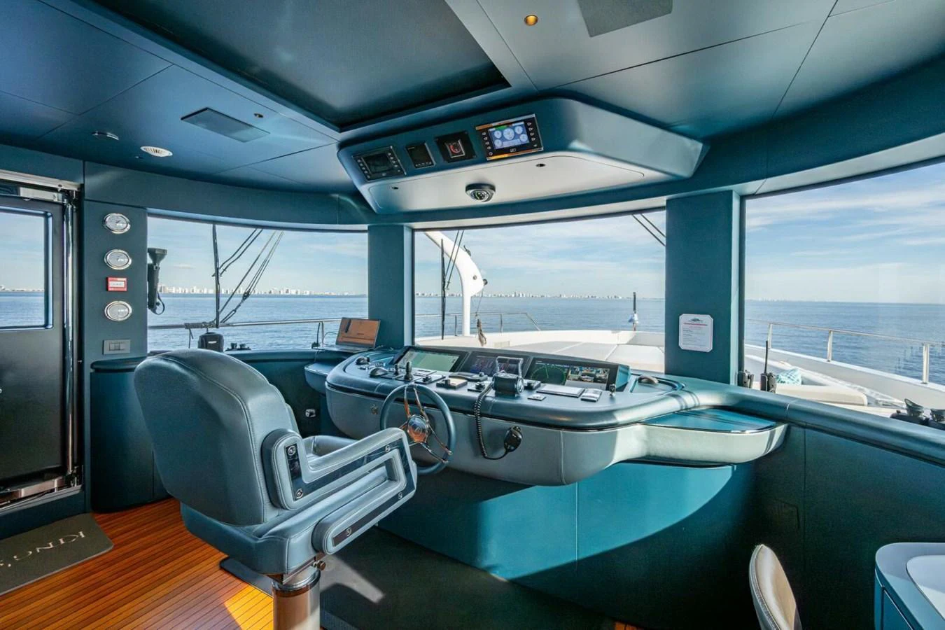 The helm station offers a commanding view with state-of-the-art navigation equipment and luxurious seating. aboard KING'S LAIR Yacht for Sale