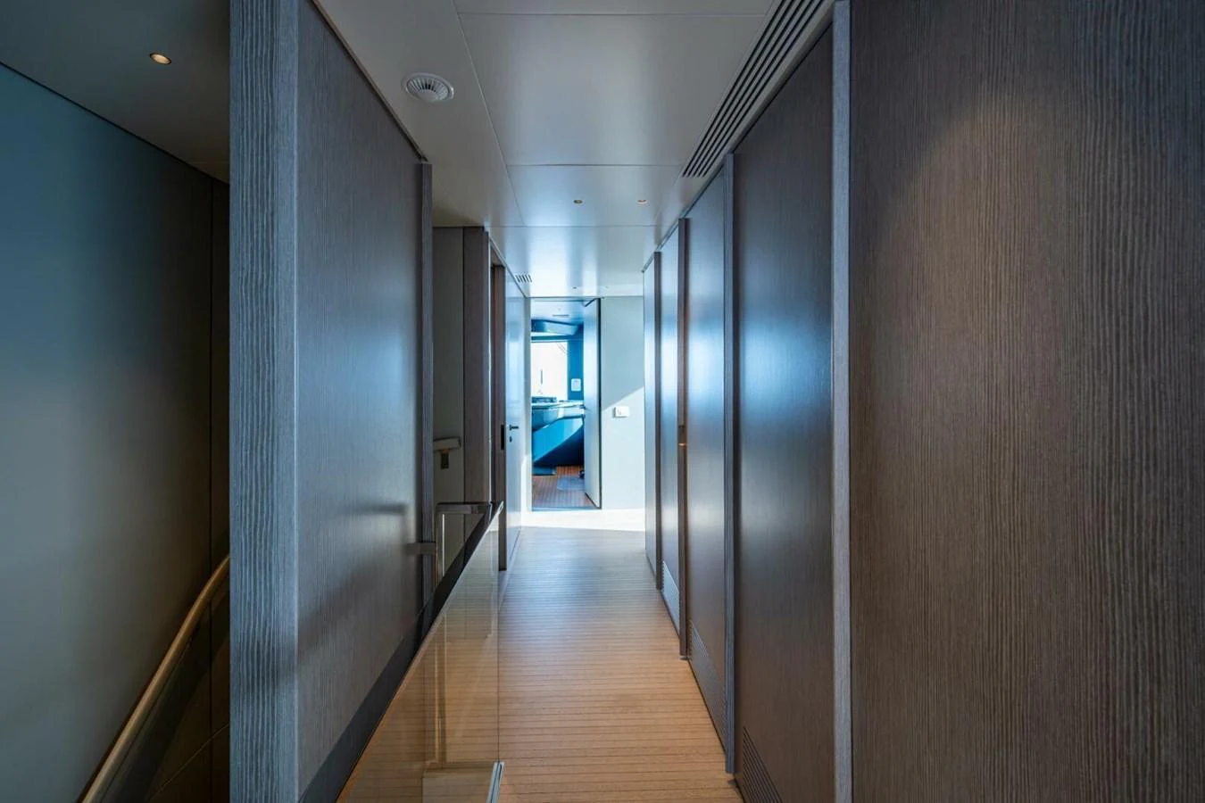 A sleek and modern hallway leading to a well-lit room on a luxury yacht. aboard KING'S LAIR Yacht for Sale