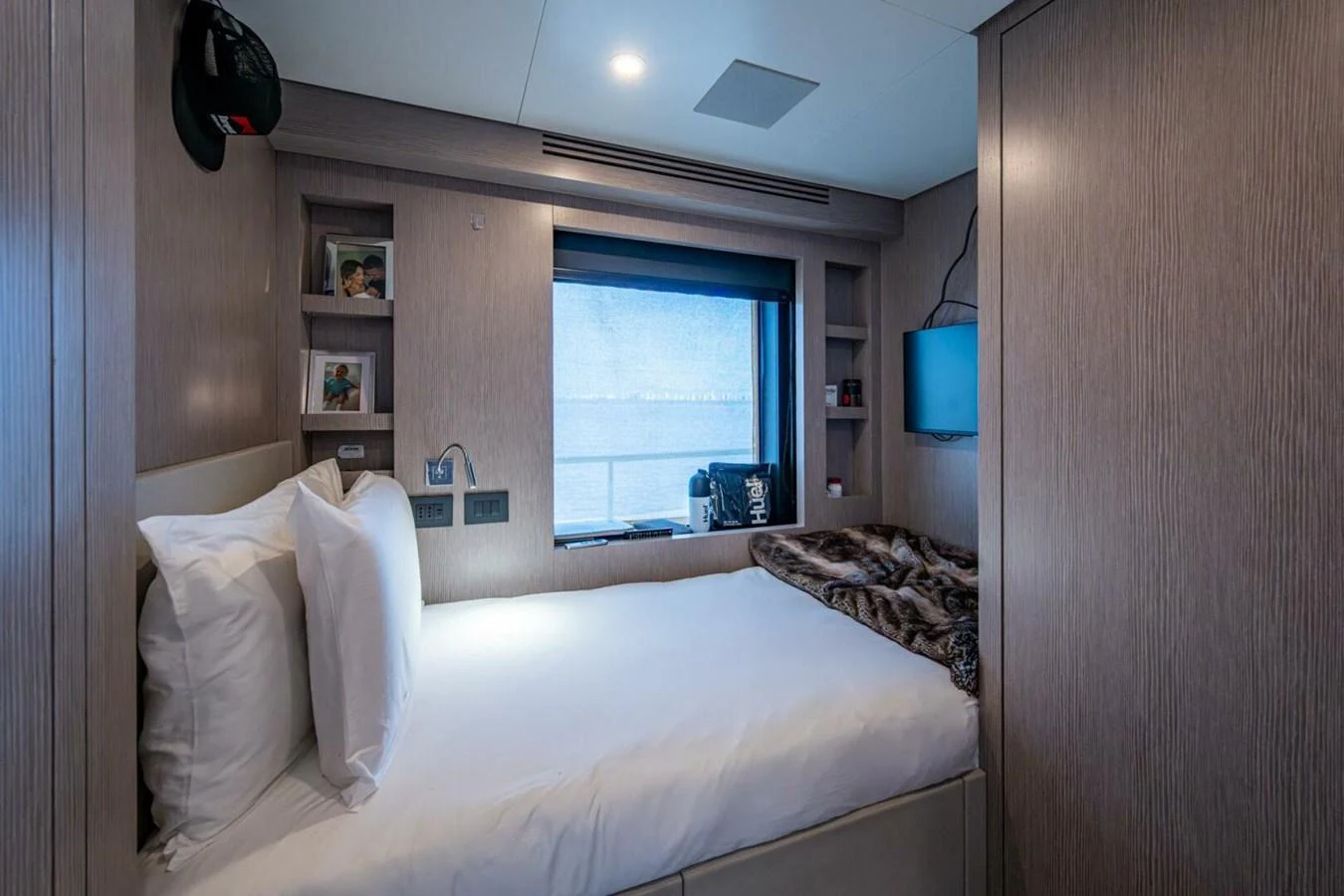 A cozy guest stateroom with a comfortable bed and modern amenities. aboard KING'S LAIR Yacht for Sale