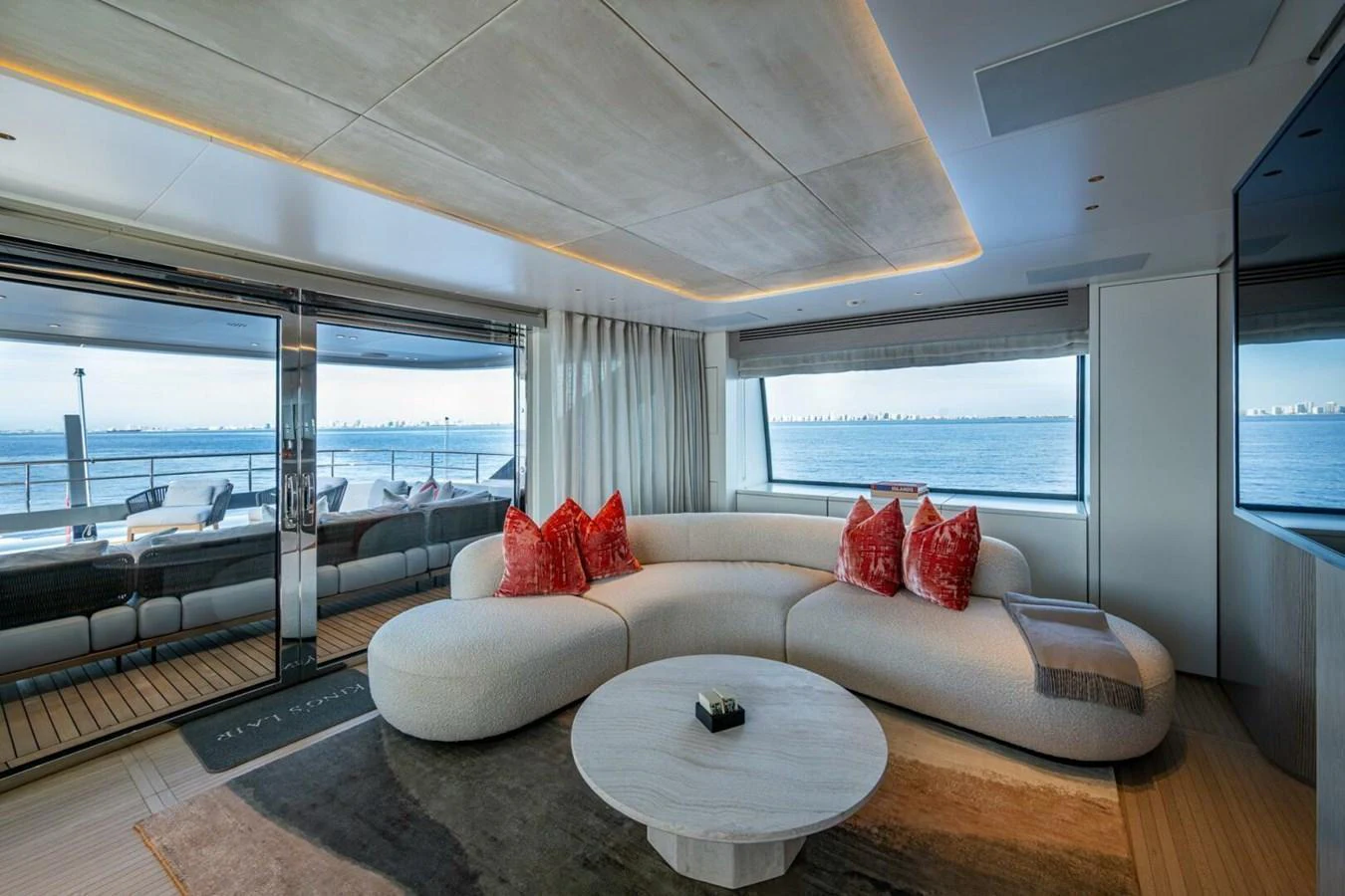The salon offers a spacious and elegant seating area with panoramic ocean views. aboard KING'S LAIR Yacht for Sale
