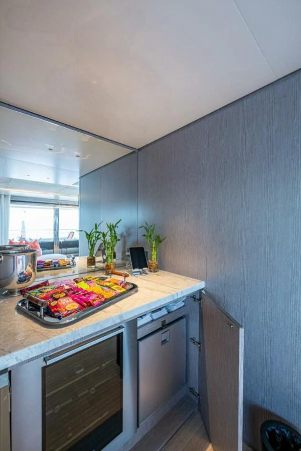 The galley features modern appliances and a sleek countertop with snacks and drinks ready for guests. aboard KING'S LAIR Yacht for Sale