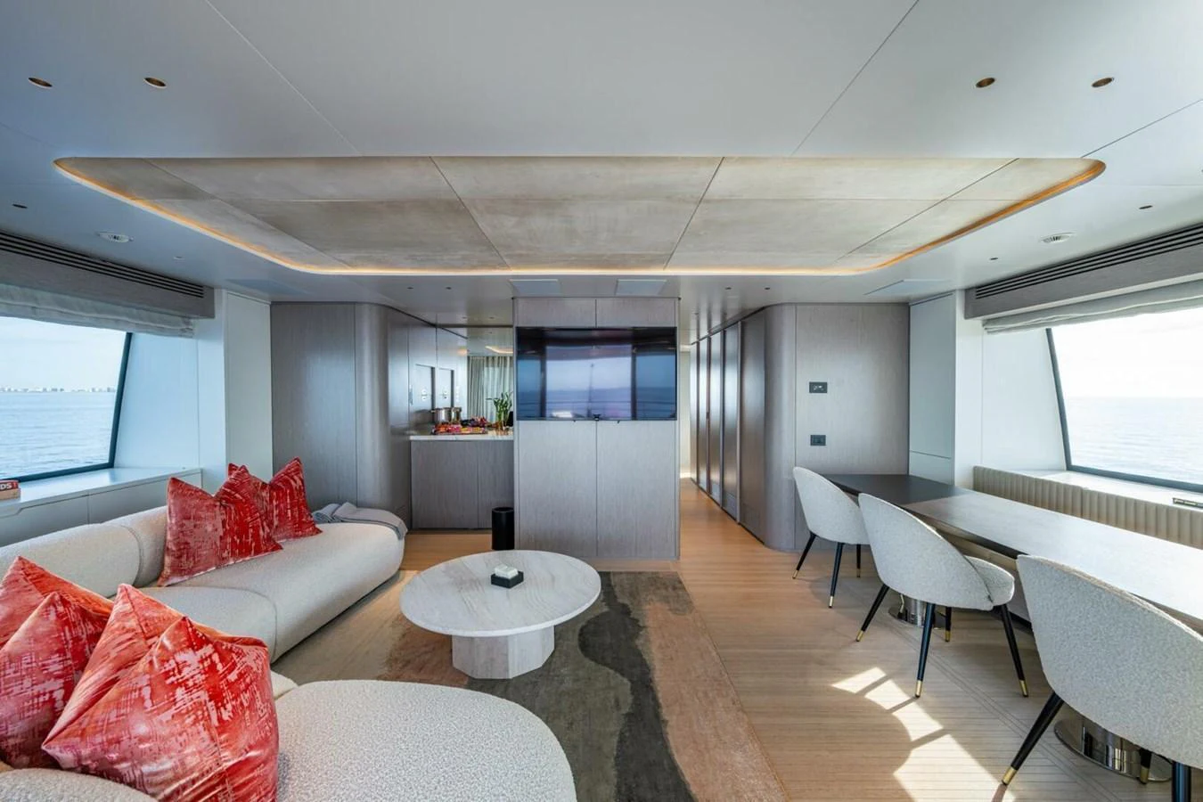 The yacht's interior features a spacious and modern living area with ample seating and large windows offering stunning views. aboard KING'S LAIR Yacht for Sale