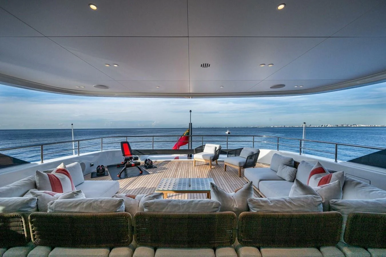 The aft deck offers a spacious and luxurious outdoor seating area with panoramic ocean views. aboard KING'S LAIR Yacht for Sale