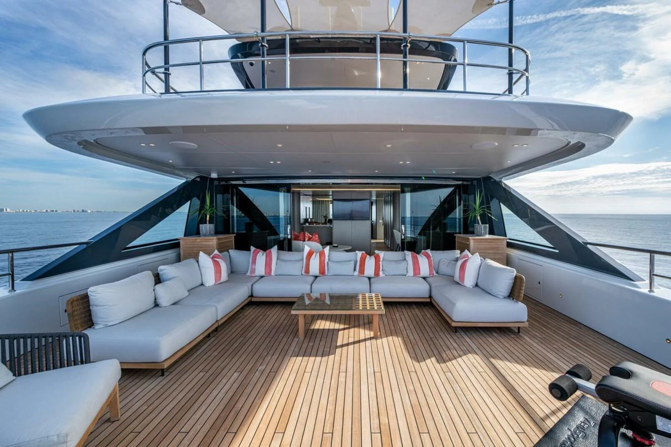 The aft deck features a spacious seating area with plush cushions and a stunning view of the sea. aboard KING'S LAIR Yacht for Sale