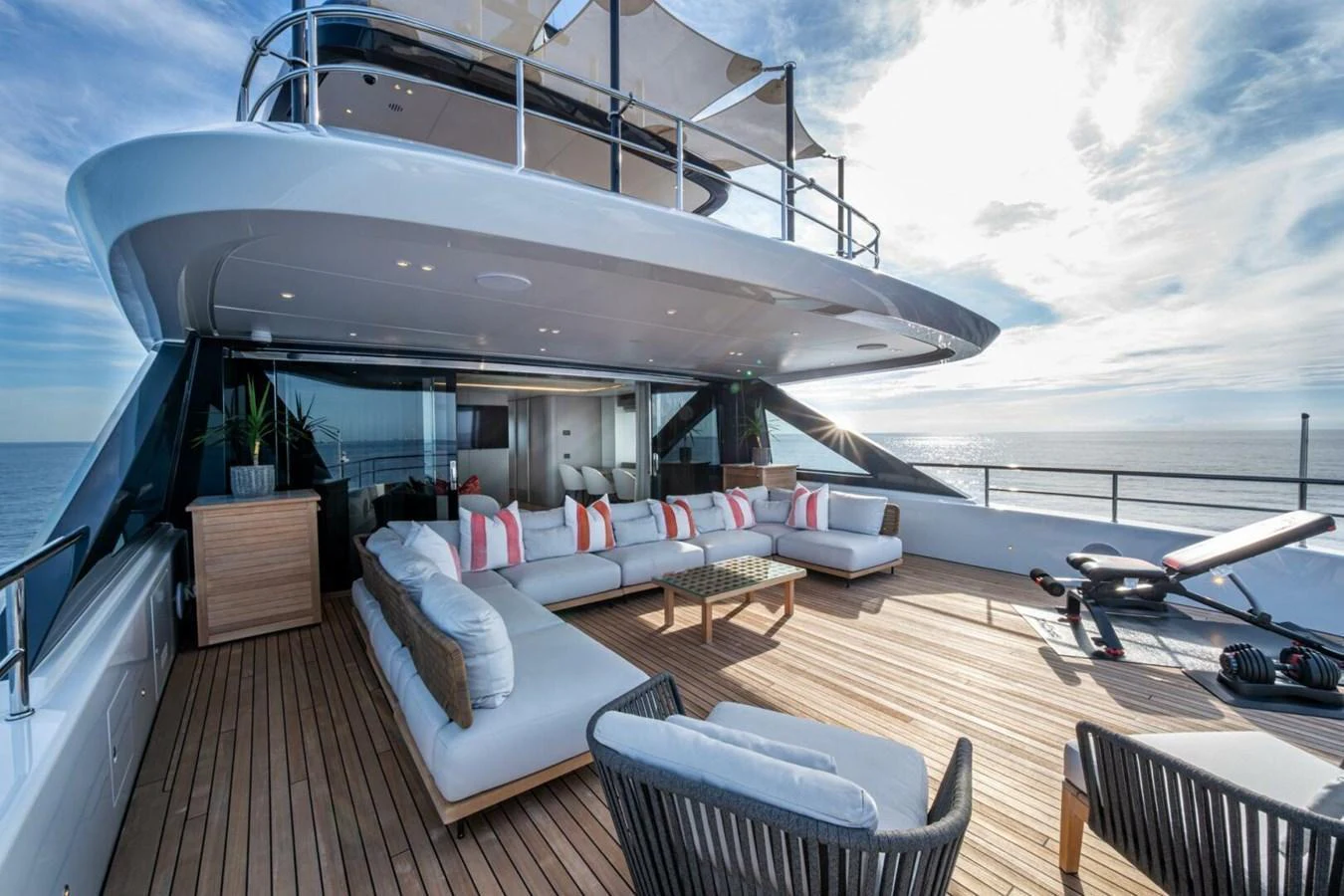 The spacious aft deck offers luxurious outdoor seating with stunning ocean views. aboard KING'S LAIR Yacht for Sale