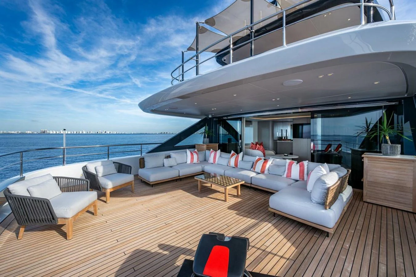 The aft deck features a spacious and stylish seating area with a stunning ocean view. aboard KING'S LAIR Yacht for Sale