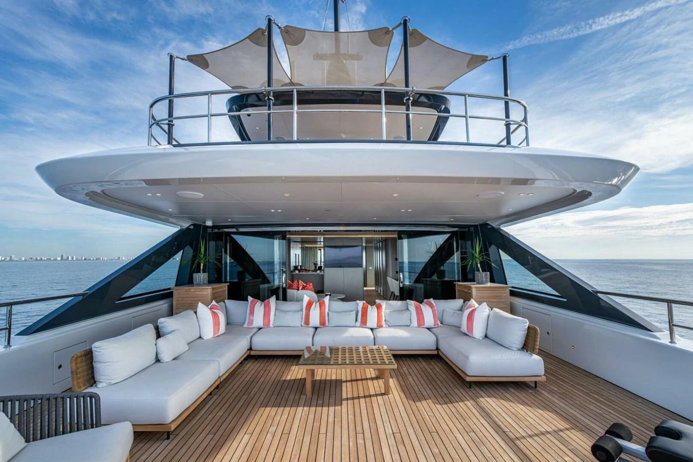 The spacious aft deck features luxurious seating with a stunning ocean view. aboard KING'S LAIR Yacht for Sale