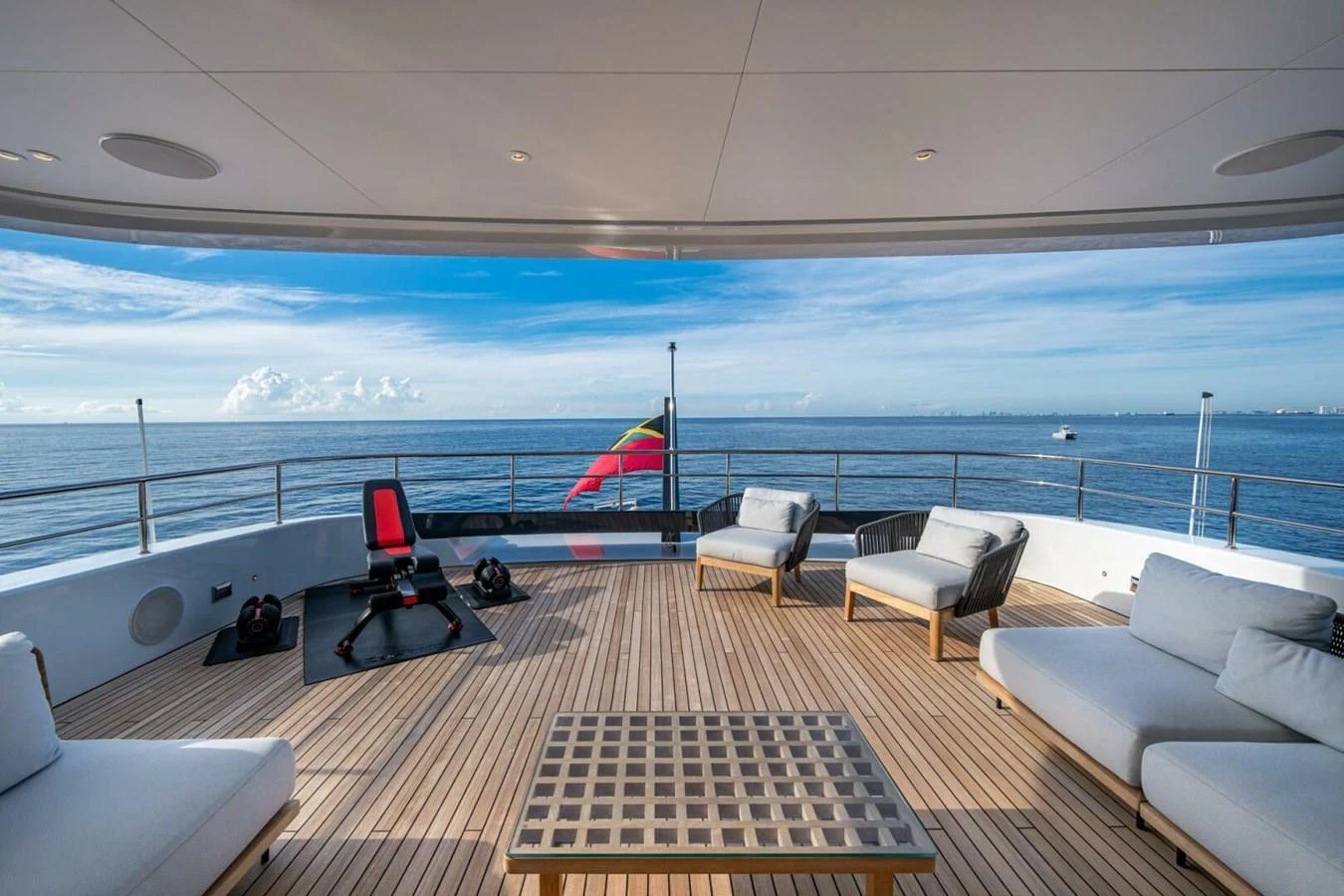 The aft deck offers a spacious and luxurious outdoor seating area with stunning ocean views. aboard KING'S LAIR Yacht for Sale