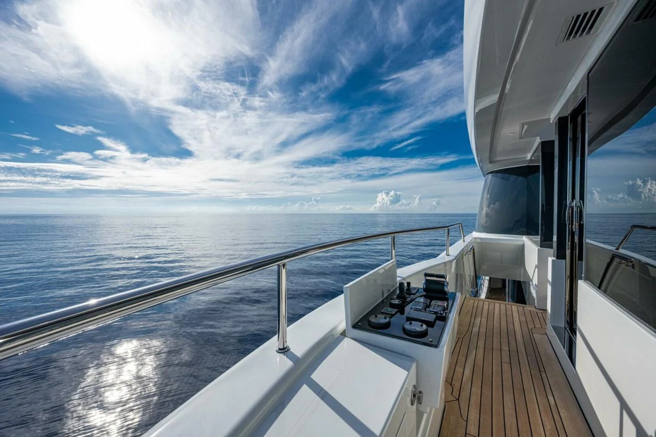 A serene view from the side deck of a yacht, showcasing the expansive ocean and clear skies. aboard KING'S LAIR Yacht for Sale