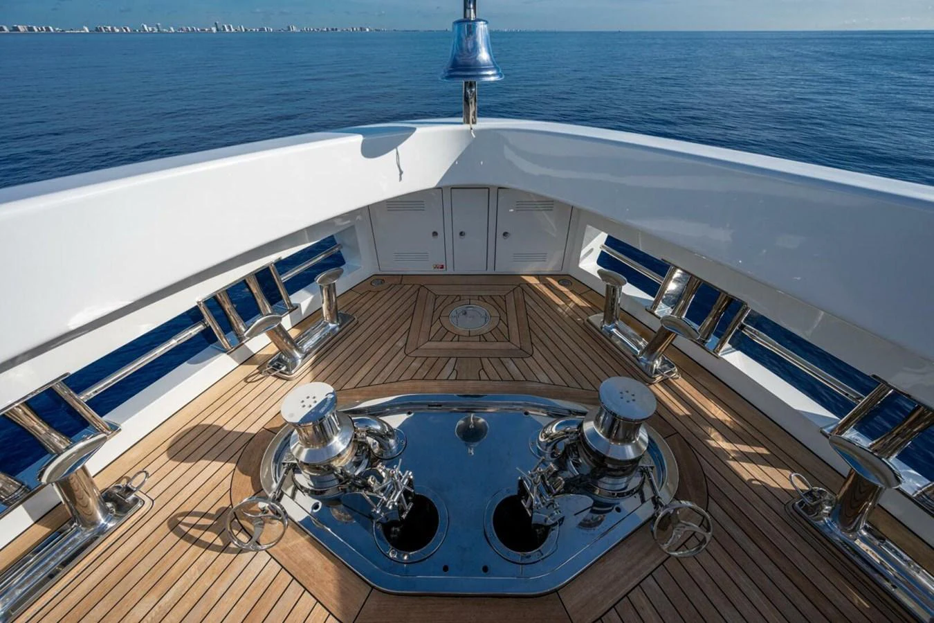 The foredeck features polished stainless steel anchor windlasses and a teak deck, showcasing meticulous craftsmanship. aboard KING'S LAIR Yacht for Sale