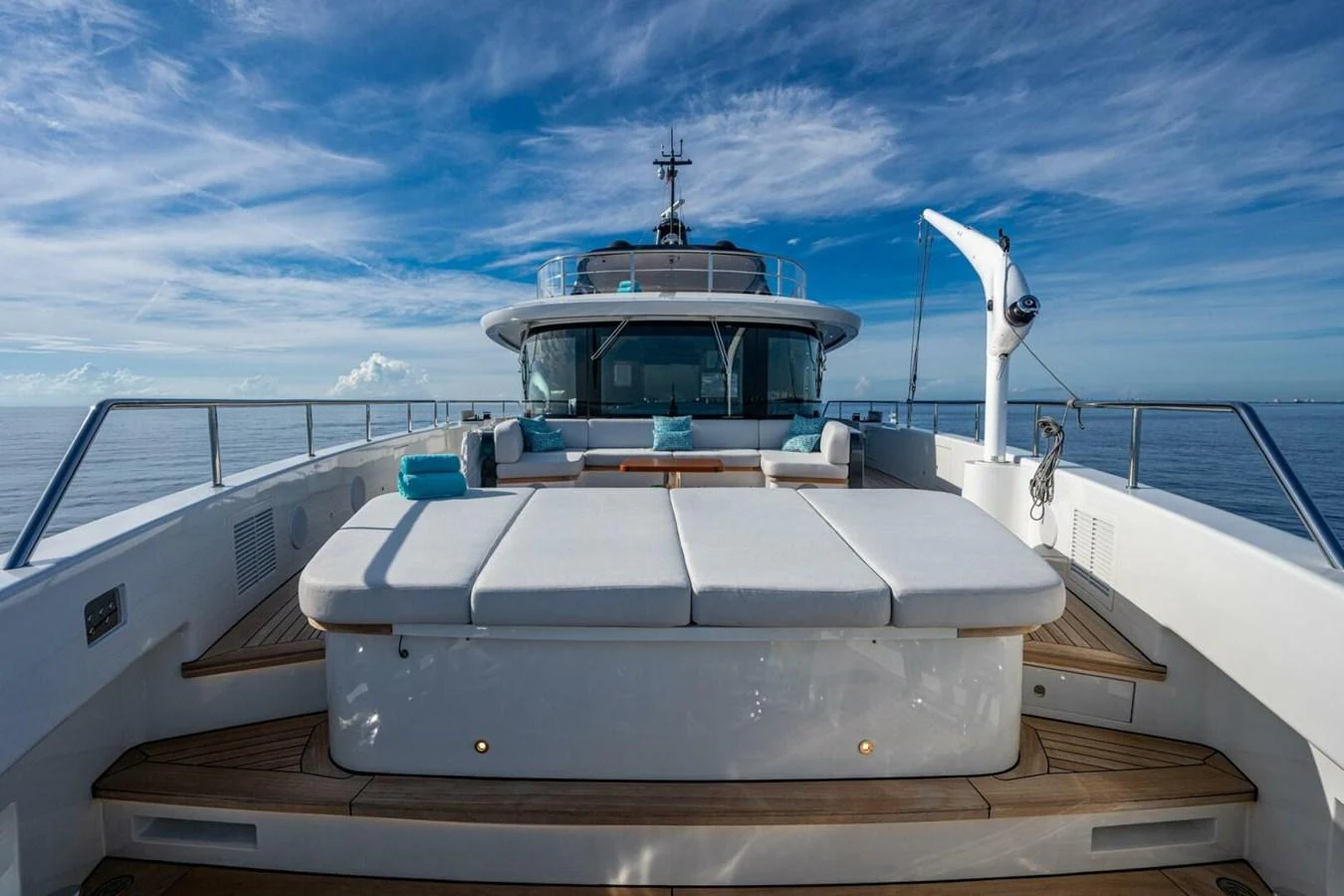 The foredeck features luxurious sun pads with a stunning ocean backdrop. aboard KING'S LAIR Yacht for Sale