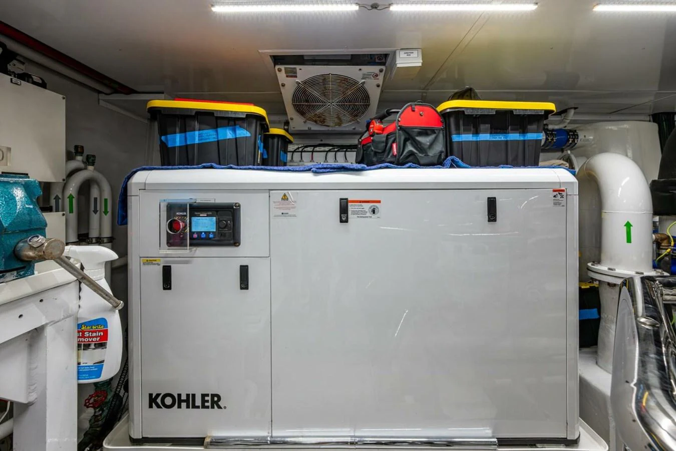 The image showcases the yacht's engine room with a Kohler generator and various equipment. aboard KING'S LAIR Yacht for Sale