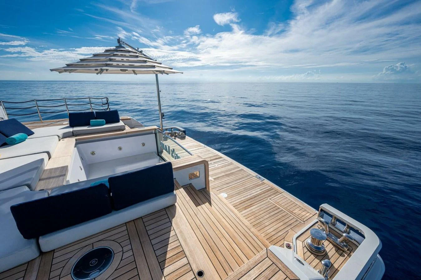 The aft deck offers a serene space with luxurious seating and a stunning view of the open sea. aboard KING'S LAIR Yacht for Sale