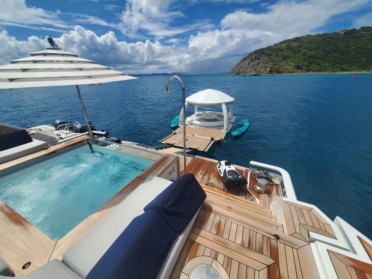 The aft deck features a luxurious jacuzzi and comfortable lounging area with stunning ocean views. aboard KING'S LAIR Yacht for Sale