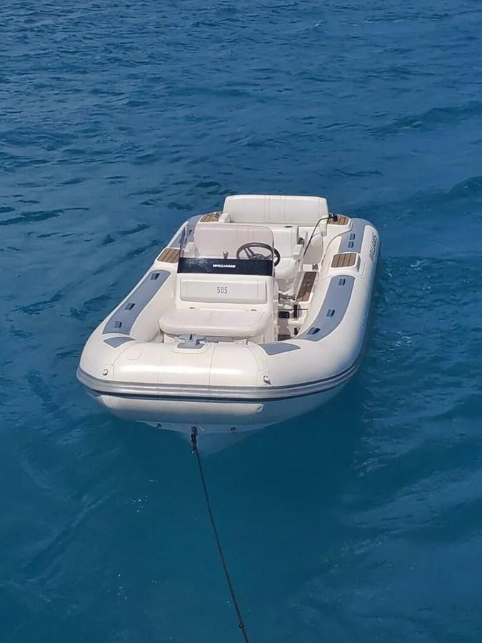 A sleek tender floats on calm blue waters, ready for excursions. aboard KING'S LAIR Yacht for Sale