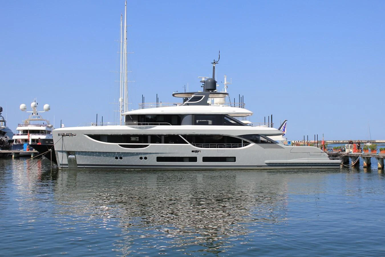 A sleek and modern yacht is docked at the marina, showcasing its elegant design and spacious decks. aboard OASIS 34M BO212 Yacht for Sale