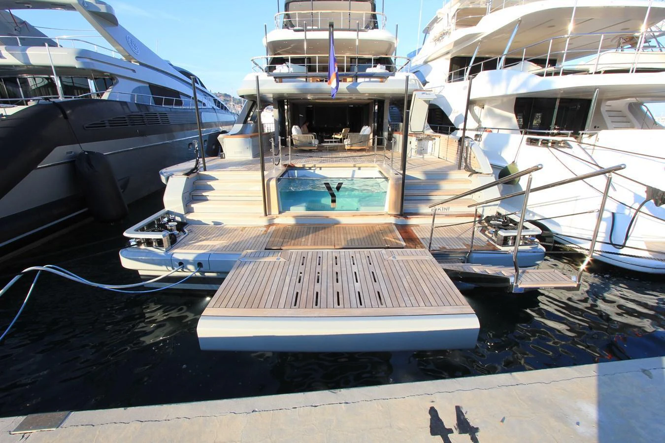 The yacht's aft deck features a spacious swim platform and a luxurious pool area, perfect for relaxation and water activities. aboard OASIS 34M BO212 Yacht for Sale