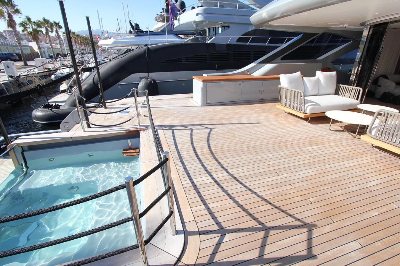 The aft deck features a luxurious seating area and a small pool, perfect for relaxation. aboard OASIS 34M BO212 Yacht for Sale