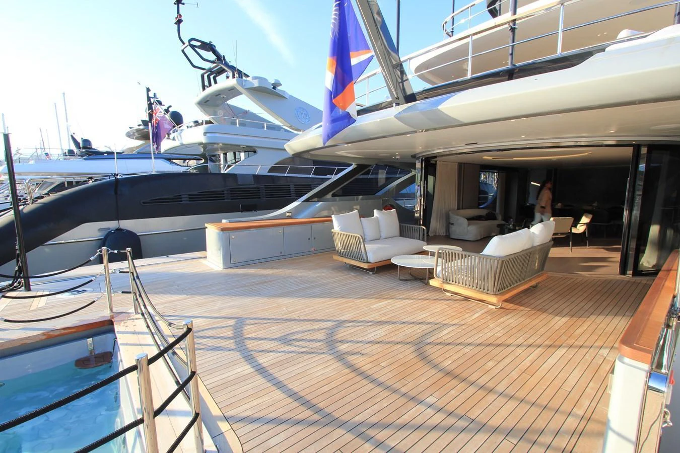 The spacious aft deck features comfortable seating and a seamless transition to the interior living area. aboard OASIS 34M BO212 Yacht for Sale