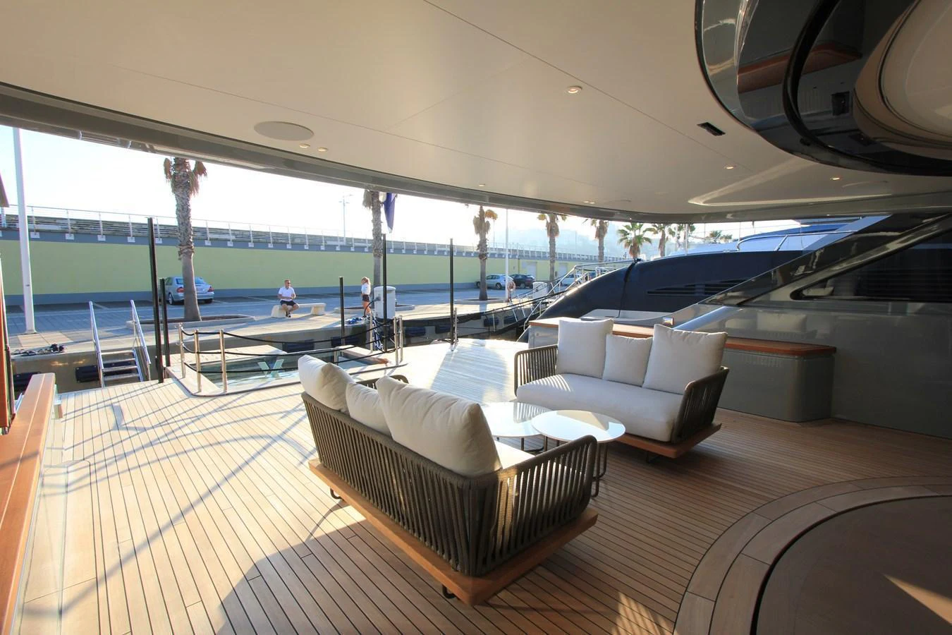 The aft deck features a spacious seating area with plush sofas and a coffee table, perfect for relaxation and socializing. aboard OASIS 34M BO212 Yacht for Sale