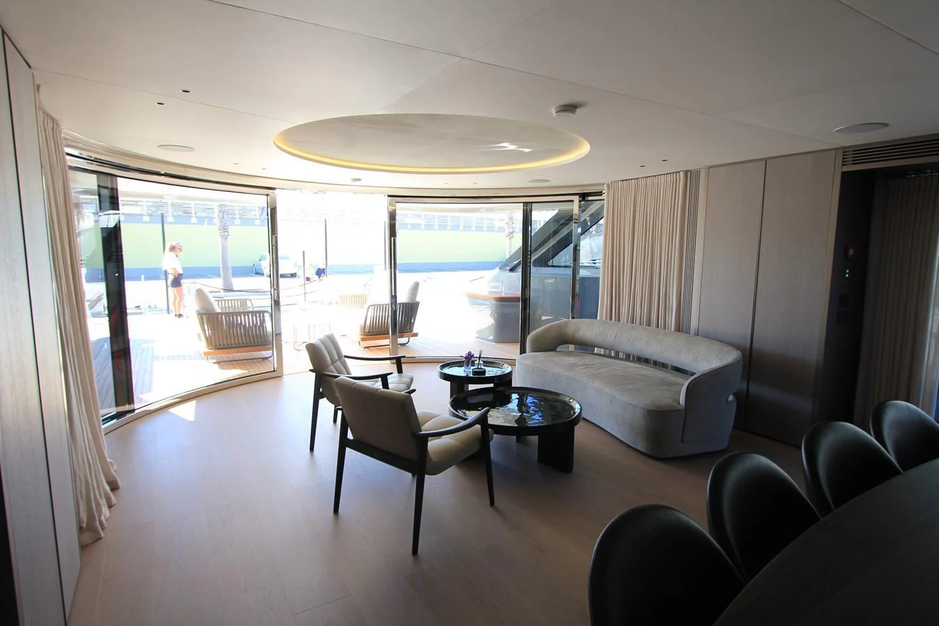 The salon features elegant seating with ample natural light from large windows. aboard OASIS 34M BO212 Yacht for Sale