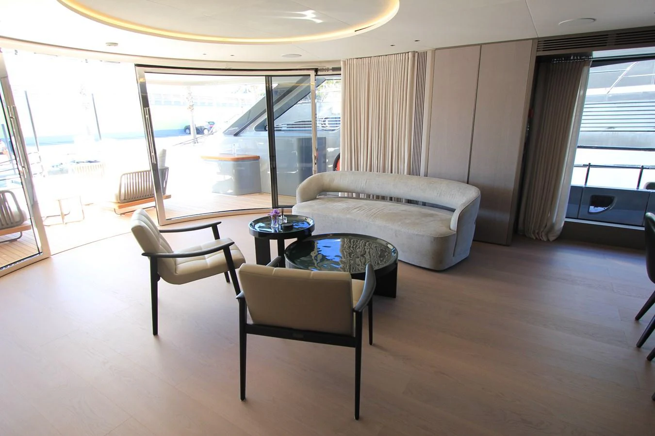 The yacht's interior features a modern seating area with large windows offering ample natural light. aboard OASIS 34M BO212 Yacht for Sale