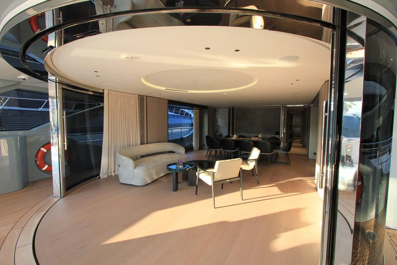 The yacht's interior features a spacious and modern lounge area with elegant furnishings and ample natural light. aboard OASIS 34M BO212 Yacht for Sale