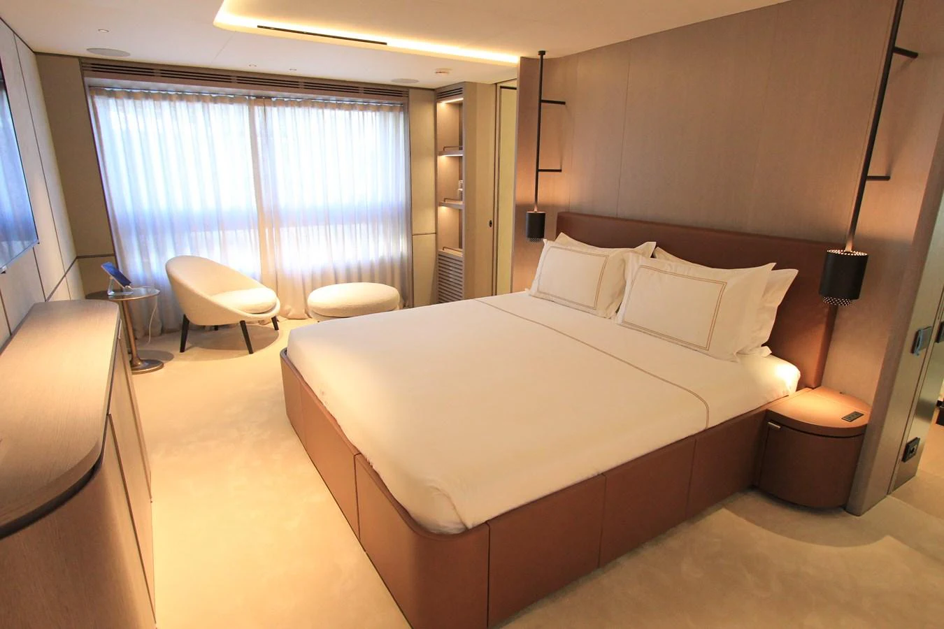 A luxurious stateroom featuring a plush bed, modern furnishings, and ample natural light. aboard OASIS 34M BO212 Yacht for Sale
