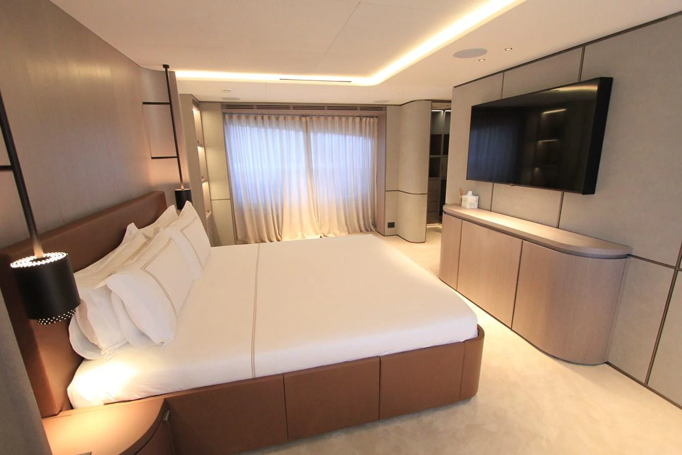The master stateroom features a luxurious bed, modern furnishings, and a large flat-screen TV. aboard OASIS 34M BO212 Yacht for Sale