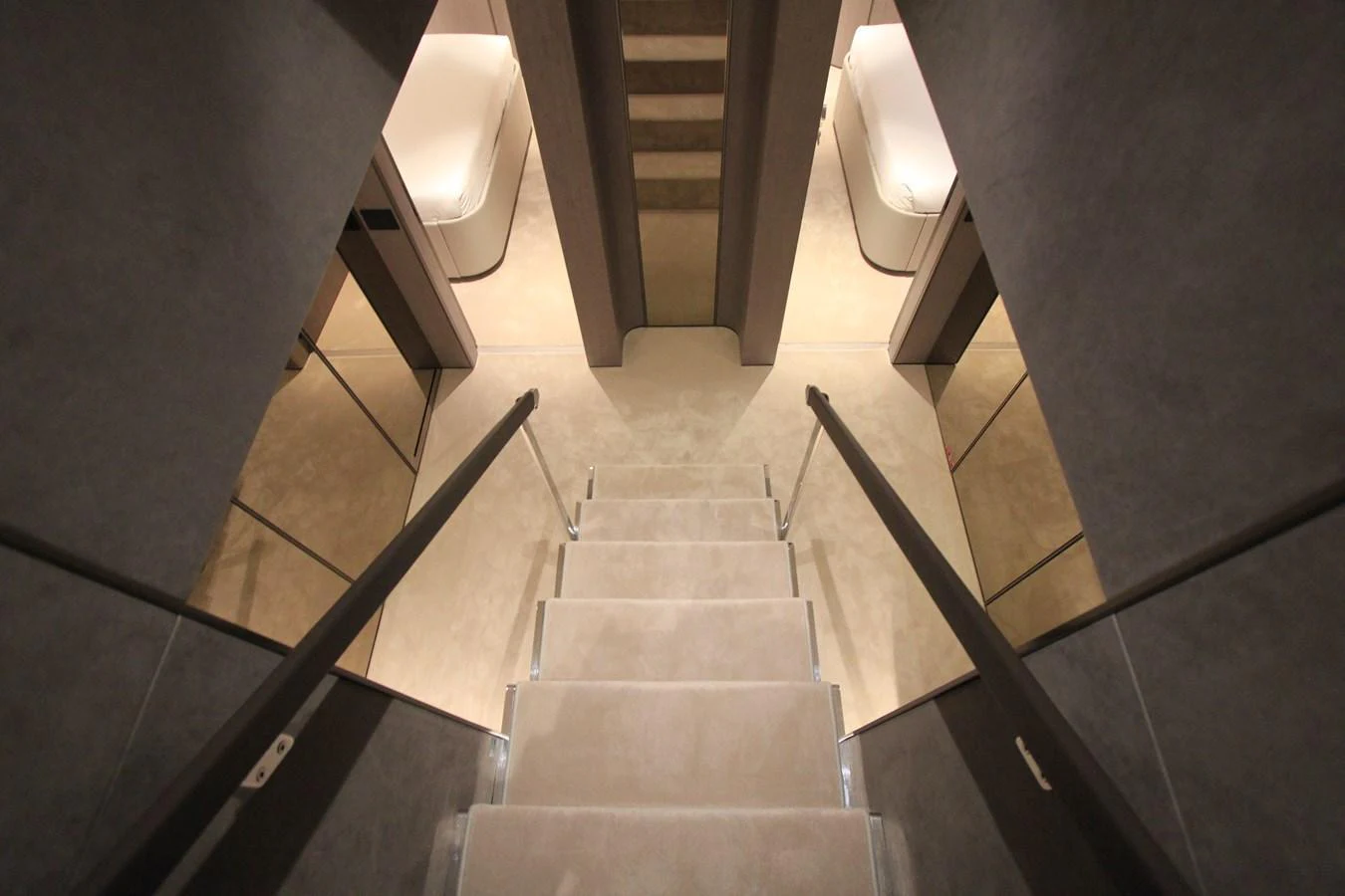 A modern staircase leads to a lower deck area with sleek, minimalist design. aboard OASIS 34M BO212 Yacht for Sale