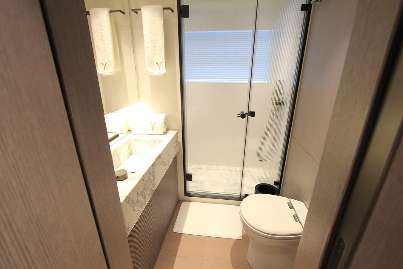 The yacht's bathroom features a sleek design with modern fixtures and a spacious shower area. aboard OASIS 34M BO212 Yacht for Sale
