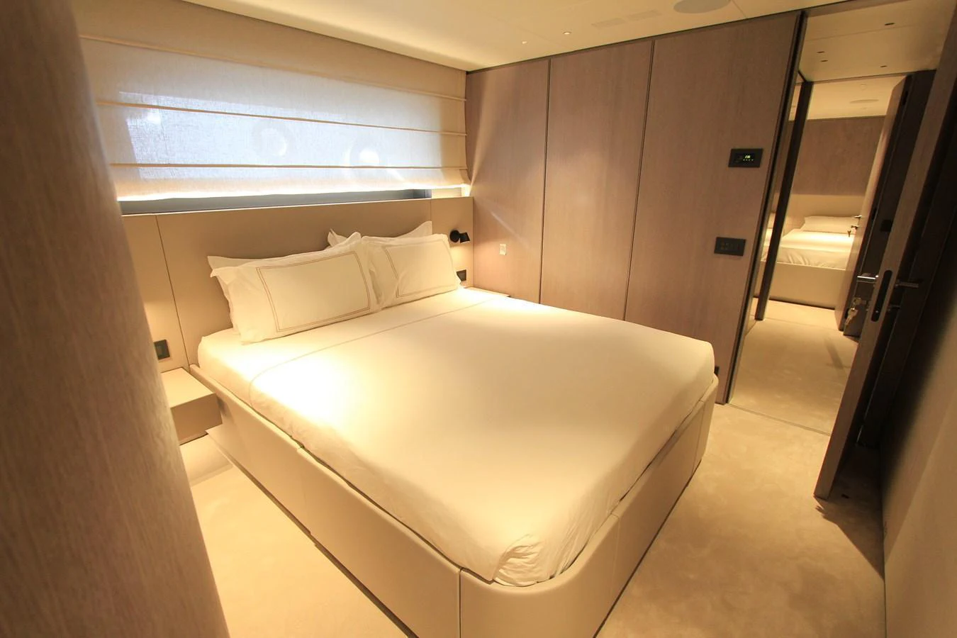 The stateroom features a plush bed with elegant bedding and soft lighting, creating a serene and inviting atmosphere. aboard OASIS 34M BO212 Yacht for Sale