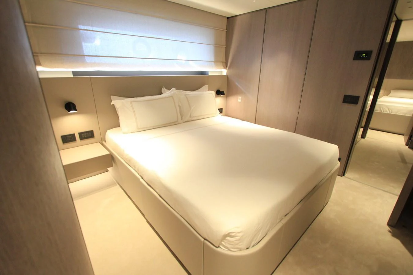 A luxurious stateroom featuring a comfortable bed with elegant lighting and modern decor. aboard OASIS 34M BO212 Yacht for Sale