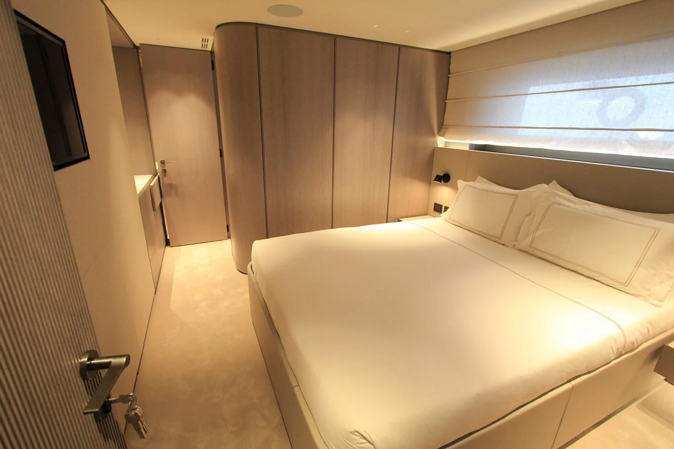 The stateroom features a plush bed with modern, minimalist decor and soft lighting. aboard OASIS 34M BO212 Yacht for Sale
