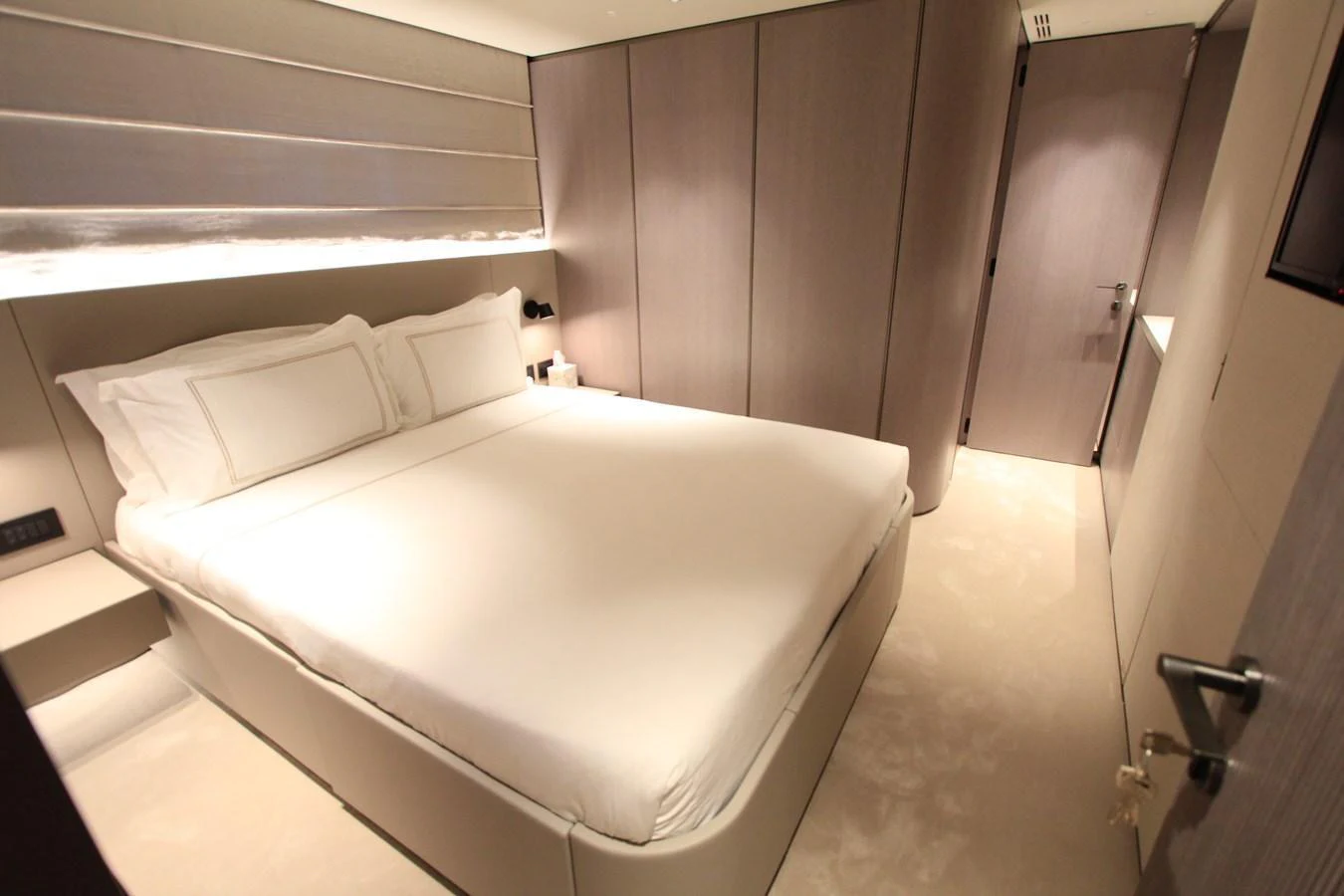 The stateroom features a plush bed with elegant bedding and modern, minimalist decor. aboard OASIS 34M BO212 Yacht for Sale