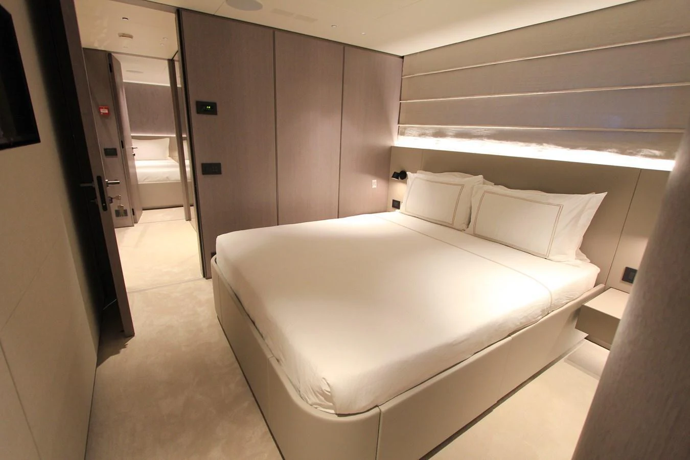 The stateroom features a luxurious bed with modern, minimalist decor. aboard OASIS 34M BO212 Yacht for Sale