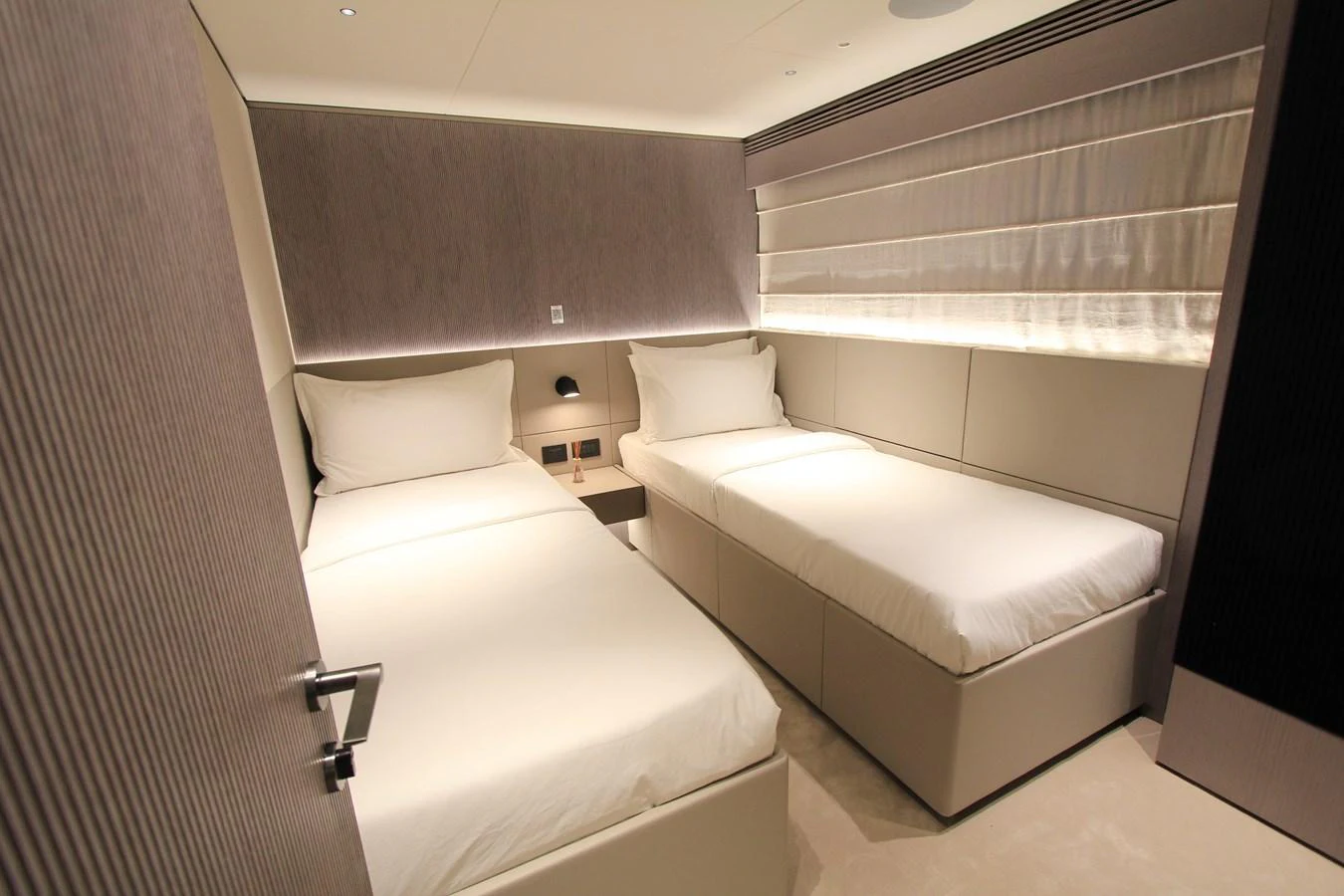 The guest stateroom features twin beds with a modern and minimalist design. aboard OASIS 34M BO212 Yacht for Sale