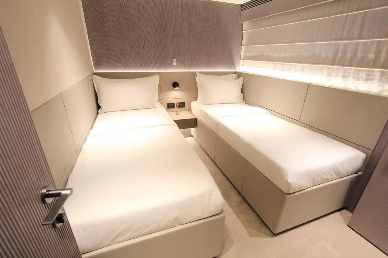 The guest stateroom features two single beds with a modern and minimalist design. aboard OASIS 34M BO212 Yacht for Sale