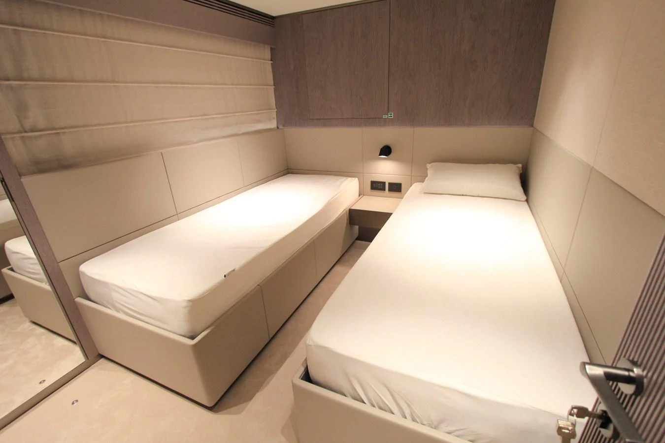 The twin stateroom offers a cozy and modern sleeping arrangement with two single beds. aboard OASIS 34M BO212 Yacht for Sale