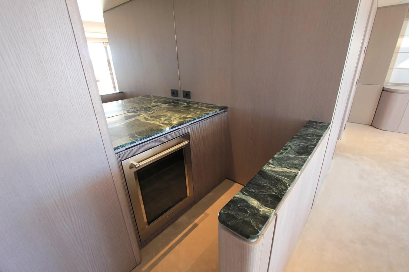 The yacht's galley features sleek cabinetry and a modern countertop with a built-in oven. aboard OASIS 34M BO212 Yacht for Sale