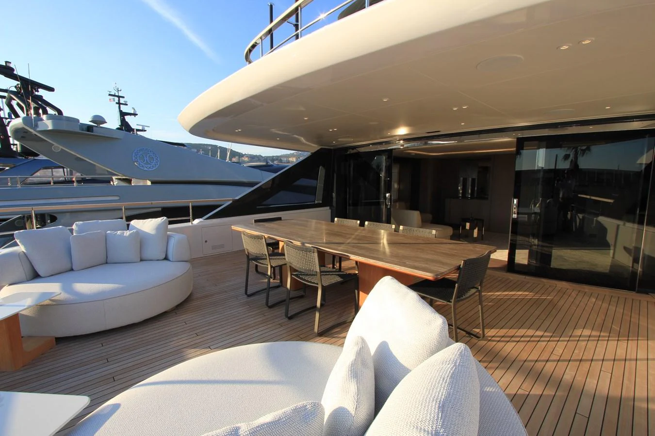 The aft deck features a spacious seating area and a large dining table, perfect for outdoor relaxation and entertainment. aboard OASIS 34M BO212 Yacht for Sale