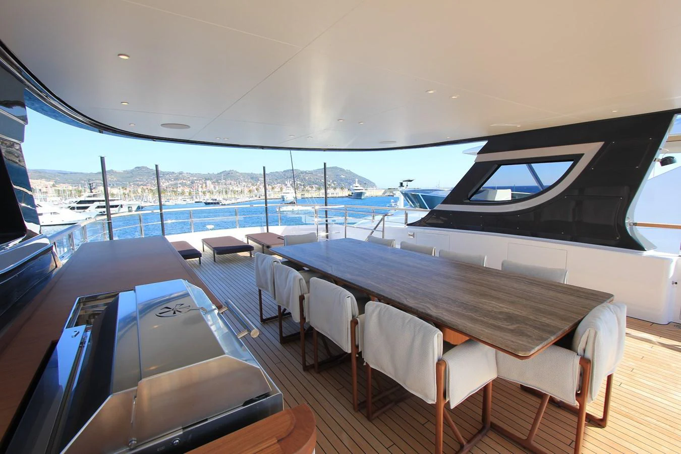 The aft deck offers a spacious dining area with panoramic views of the marina. aboard OASIS 34M BO212 Yacht for Sale